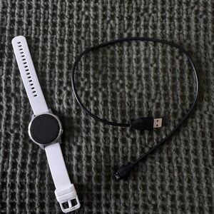 garmin vivoactive 4s white smartwatch with black charger cable